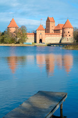 Fototapeta na wymiar Medieval castle of Trakai, Vilnius, Lithuania, Eastern Europe, located between beautiful lakes and nature with wooden pier 