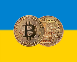 golden coin bitcoin on the Ukrainian flag
