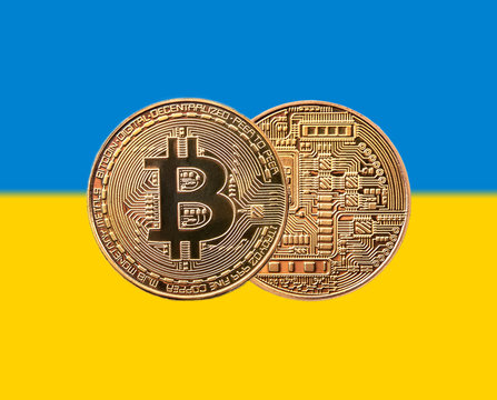 golden coin bitcoin on the Ukrainian flag