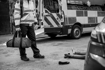 Male paramedic responding to a car accident