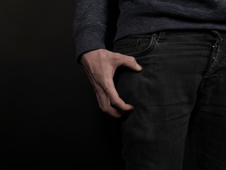 Tensed hand gripping leg