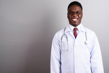 Young African man doctor against white background