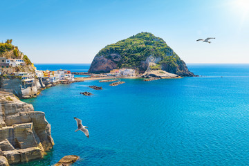 Giant green rock near small town Sant'Angelo on Ischia island, Italy