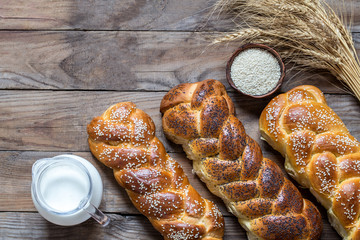 traditional Jewish challah bread on wooden background from boards