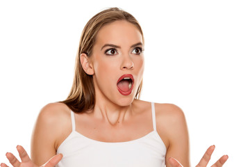 Beautiful shocked girl on white background
