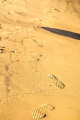 Footprints at sunset on the sand