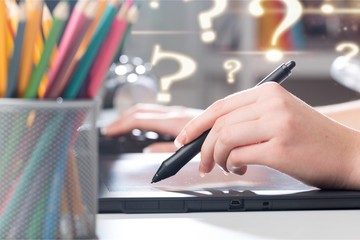 Hand of the designer with a pen