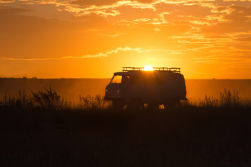 minivan is driving along a country road