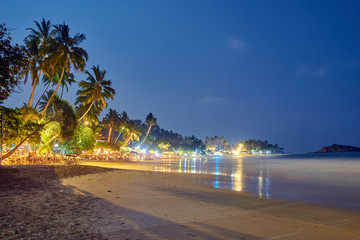 cafes, restaurants and nightclubs on the shore of the Indian Ocean in Sri Lanka at night