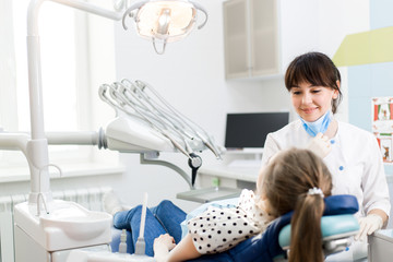 Fototapeta premium Dentist examines the oral cavity of the patient in the clinic