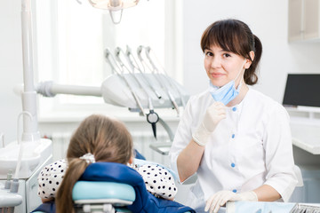 Dentist examines the patient's mouth in the clinic