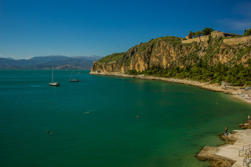 vacation concept of tropic south resort nature place rocks cape and sea bay with vivid colorful water, yachts and swimming people 