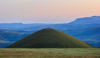 Early morning in the mountain area. Dawn over the mountains and valleys of the North Caucasus in Russia.