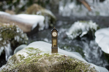 Vintage antique standing clock by the riverside
