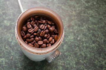 coffee beans in a coffee grinder