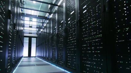 Looped Cinemagraph: Working and Active Data Center with Server Racks Full of Blinking LED Lights.