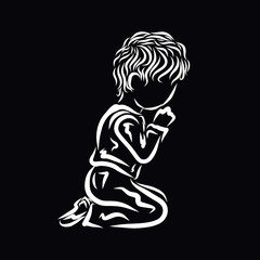 A child humbly praying to God on his knees, black background