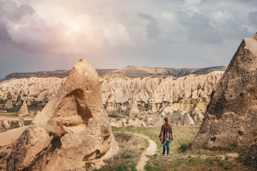 Woman walking and enjoying Cappadocia mountain landscape