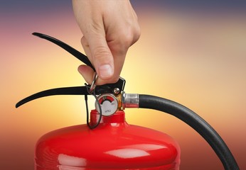 Hand presses the trigger fire extinguisher hand