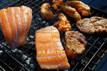 Salmon stake frying outside on the fire