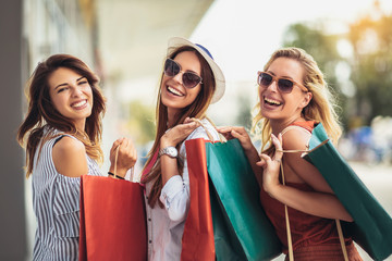 Beautiful woman with shopping bags in the city-sale, shopping, tourism and happy people concept