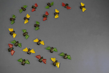 multicolored gummy jelly bat candies over dark background