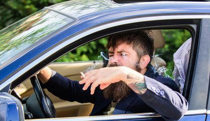 Driver smoking cigarette. Minute to relax. Businessman tired after hard negotiations smoking...