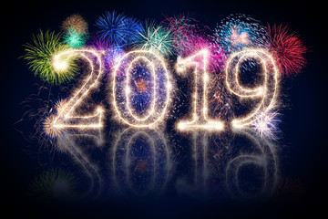 colorful fireworks display and bright sparkler pyrotechnic number 2019 happy new year sylvester concept on black blue background