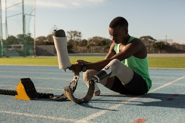 Disabled athlete wearing prosthetic legs on running track