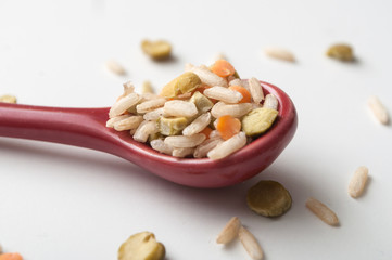 closeup of rice, split peas and  lentils on white background