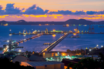 Obraz premium Laemchabang Port, Chonburi Province, Container Cargo freight ship with working crane bridge in shipyard at dusk