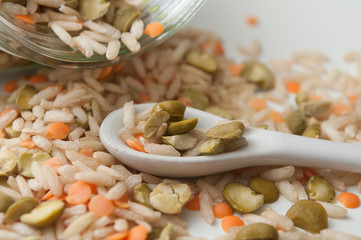 closeup of rice, split peas and  lentils on white background