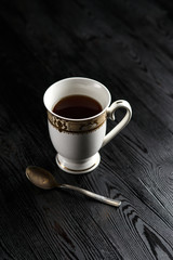 cup of coffee and spoon on a dark background