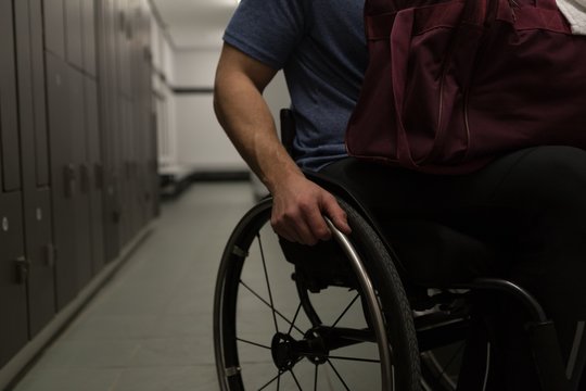 Disabled man with his bag in locker room