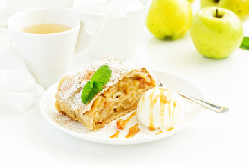 apple strudel with cinnamon and an ice cream ball.