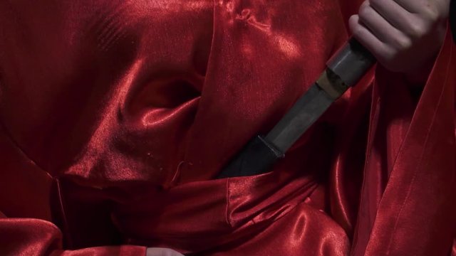 Pulling out a knife in slow motion, close up