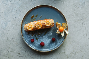 eclair cake on a plate decorated with citrus