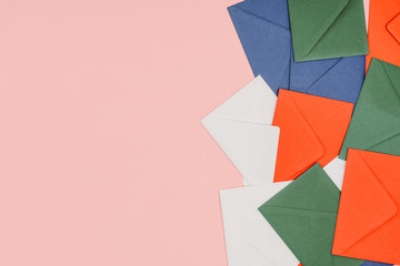 top view of colorful envelopes isolated on pink background