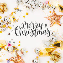 Fototapeta na wymiar Christmas frame. Christmas decorations in gold colors on white background with empty copy space for text. Holiday and celebration. Flat lay, top view