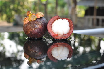 Mangosteen fruit, cross section showing the thick purple skin, queen of fruits.