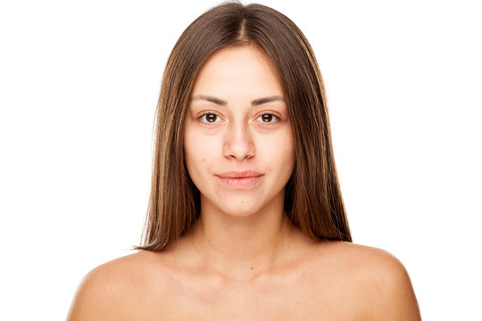 Portrait of young beautiful smiling woman with no makeup on white backgeound