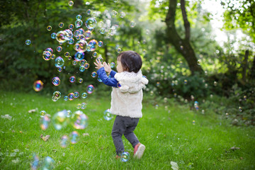 baby girl play bubble at Spring garden