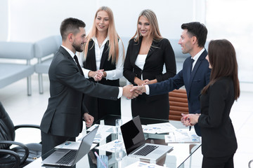 handshake business partners after discussion of the contract