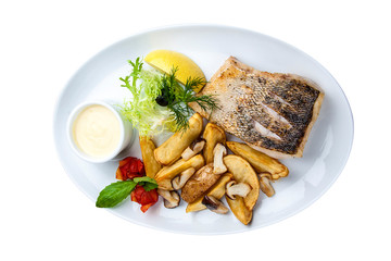 Pike perch with porcini mushrooms and potatoes. On a white plate
