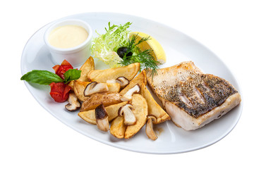 Pike perch with porcini mushrooms and potatoes. On a white plate