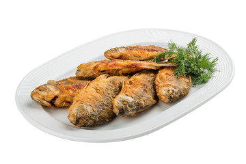 Fried carp on a white plate