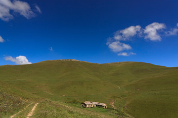 Country road without asphalt in the mountains. Photographed in the Caucasus, Russia.