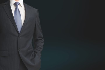 Midsection view of businessman in suit on black