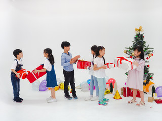 group of kids celebrate party and enjoy christmas fun together,Children are exchanging gifts.