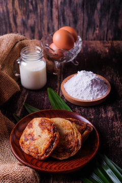 Akok Kedut, egg, coconut, flour , coconut milk and  Pandan leaf on wooden background. Akok Kedut is a traditional dish in Malaysia especially East Coast.